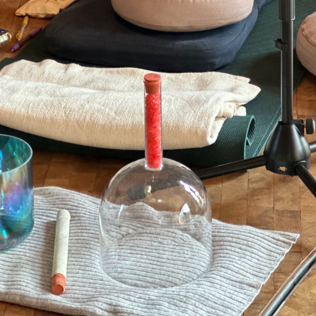 clear handle singing bowl on grey blanket