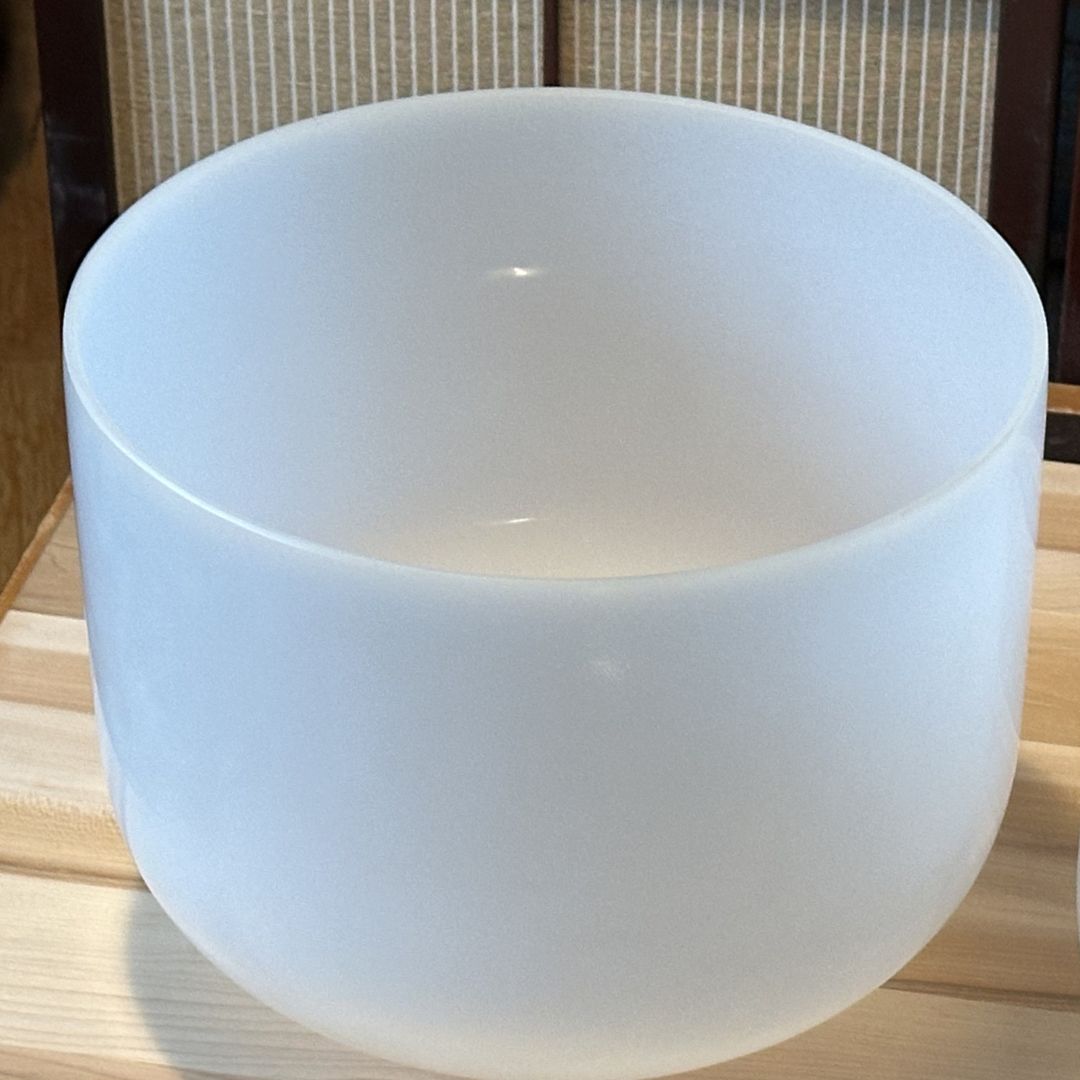 empyrean crystal singing bowl on wooden surface