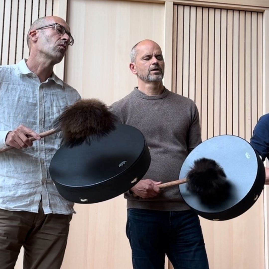 people playing a vegan drum with a beater