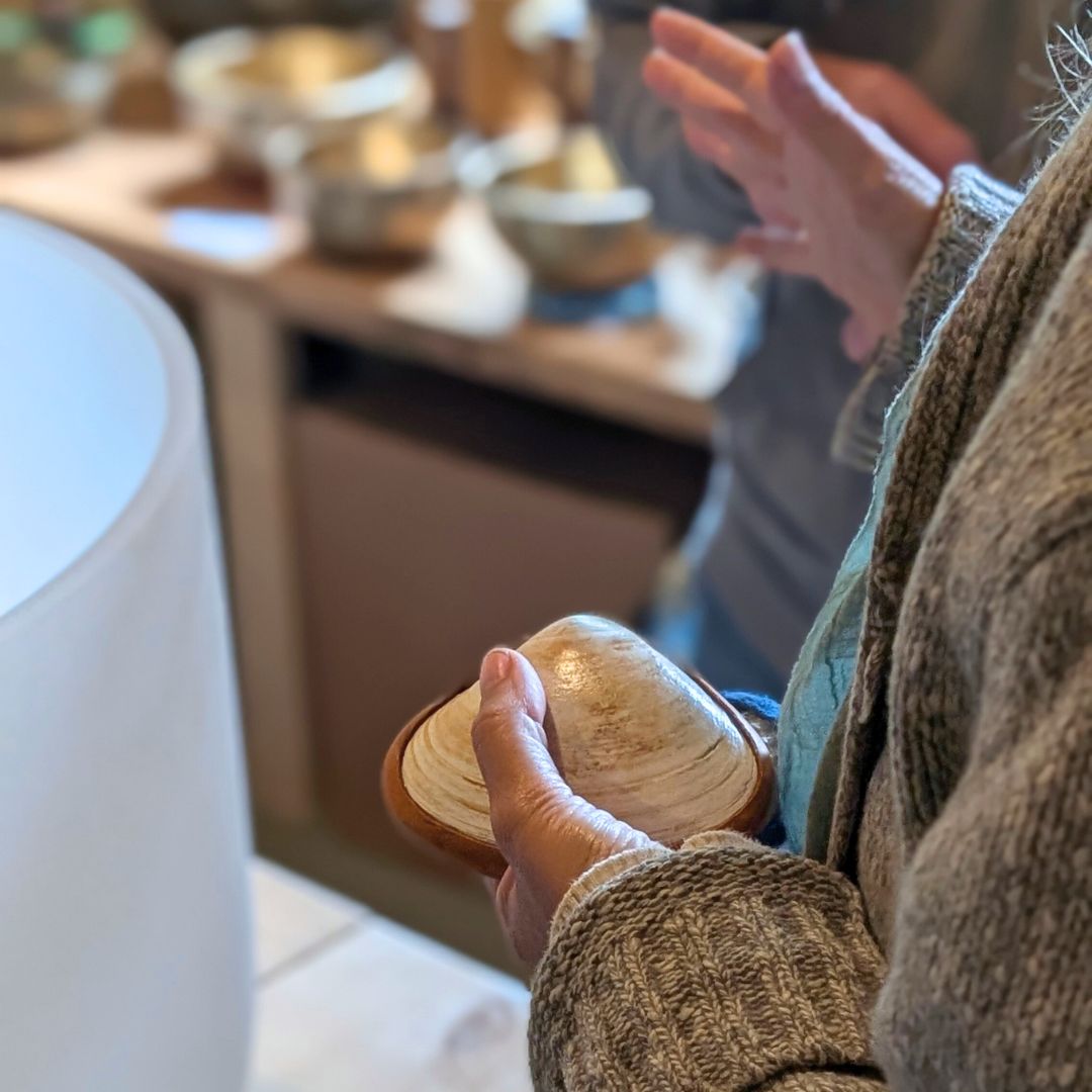 Person holding a shell rattle in the Sunreed retail store