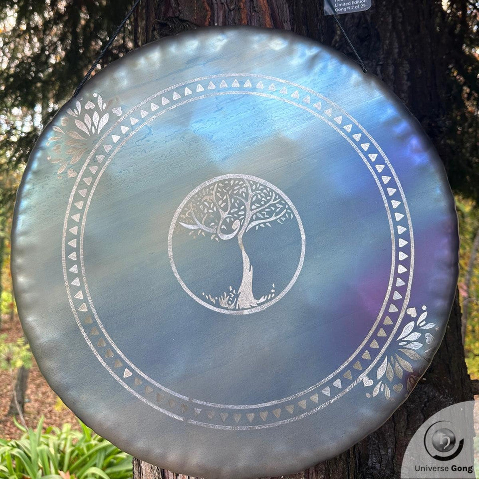 Decorative gong with tree design on a tree trunk